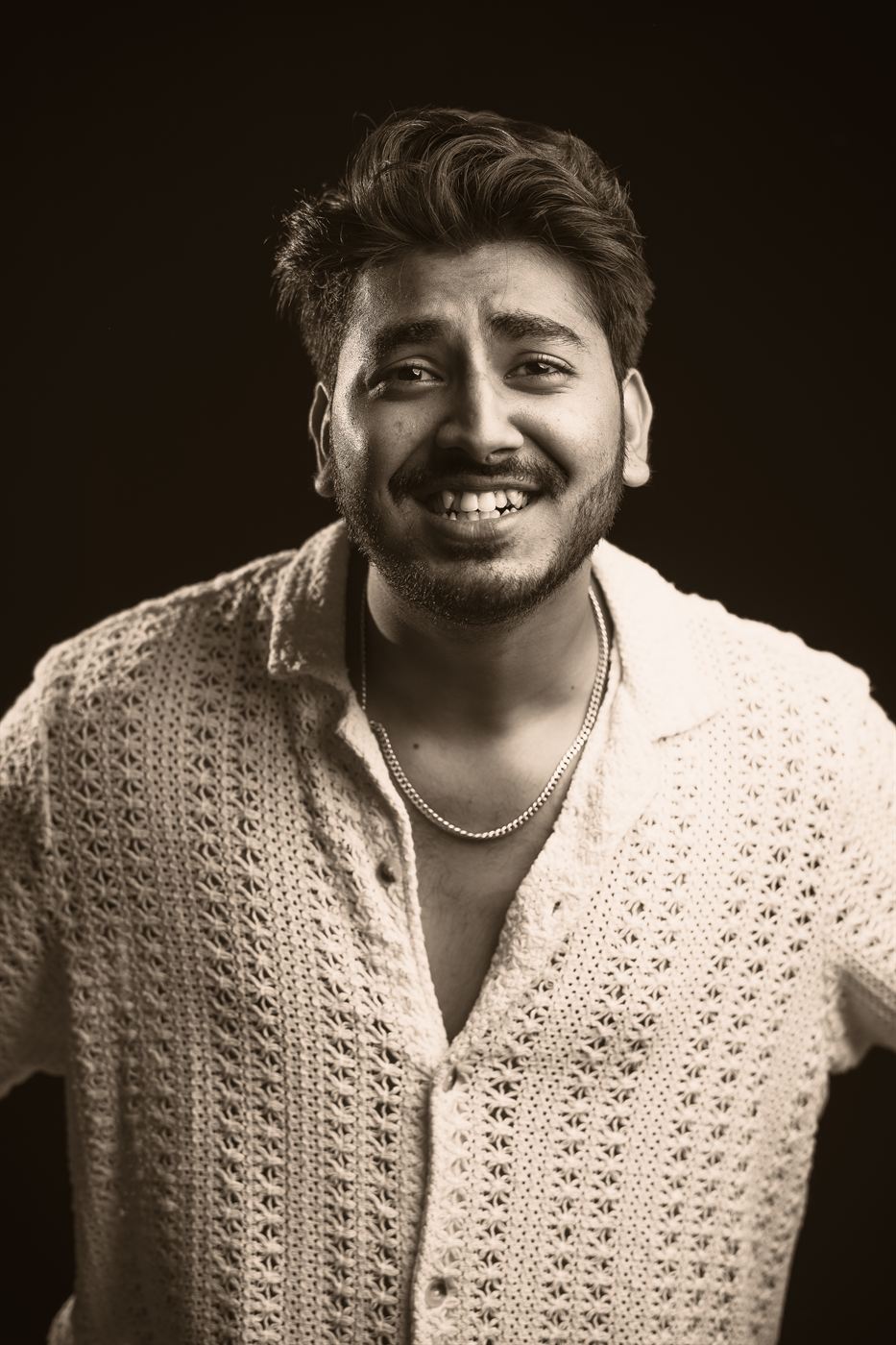 Black and white portrait of Chiraag smiling